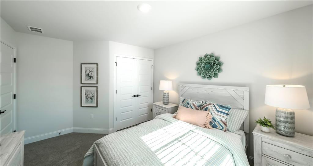 213 Laney Drive Carrollton, GA 30117 - Photo 19 of 36 a bedroom with a bed and a lamp on dresser