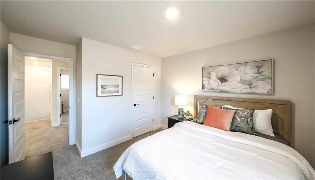 213 Laney Drive Carrollton, GA 30117 - Photo 21 of 36 a bedroom with a bed and a painting on the wall