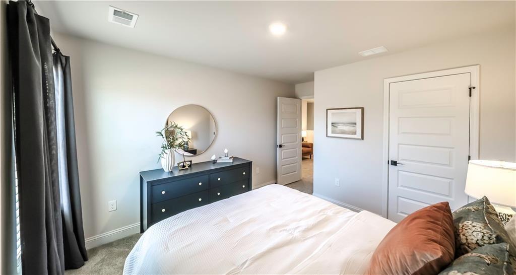 213 Laney Drive Carrollton, GA 30117 - Photo 22 of 36 a bedroom with a bed and a dresser