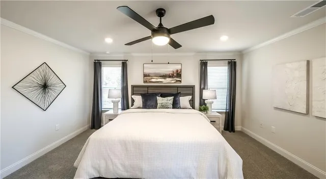 a spacious bedroom with a large bed and a chandelier