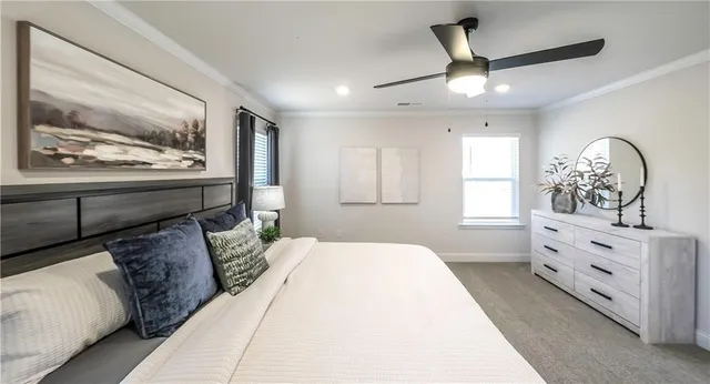 a bedroom with a large bed and a chandelier