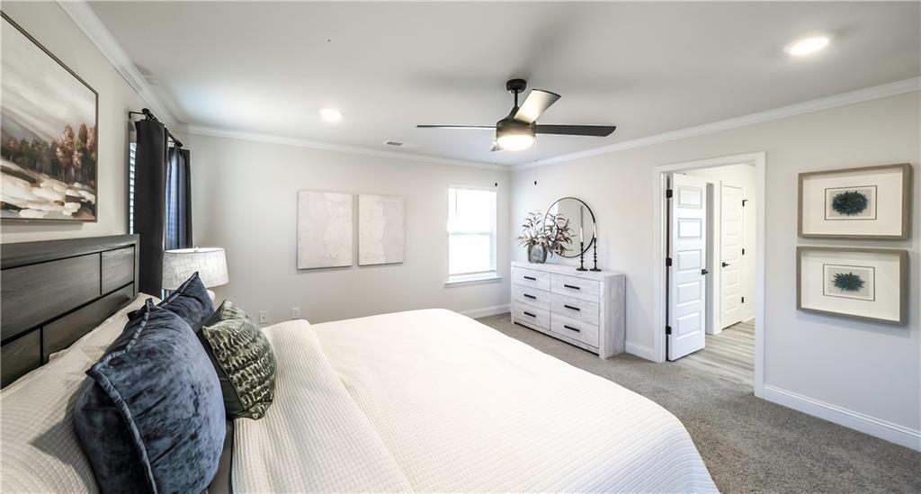 213 Laney Drive Carrollton, GA 30117 - Photo 28 of 36 a spacious bedroom with a large bed and a flat screen tv