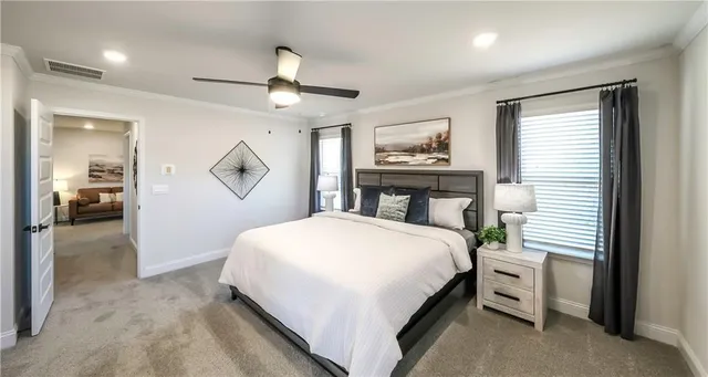 a bedroom with a large bed and a chandelier