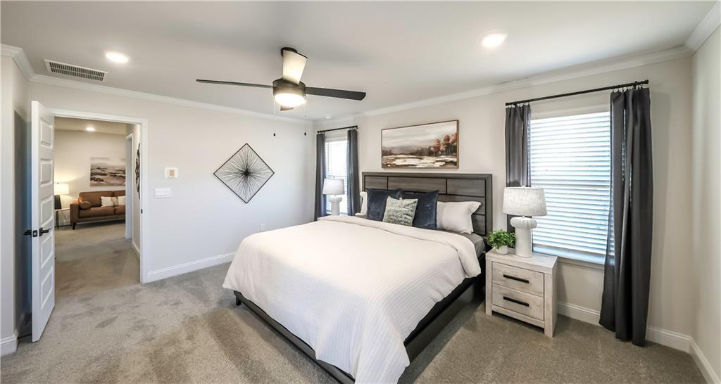 213 Laney Drive Carrollton, GA 30117 - Photo 30 of 36 a bedroom with a large bed and a chandelier