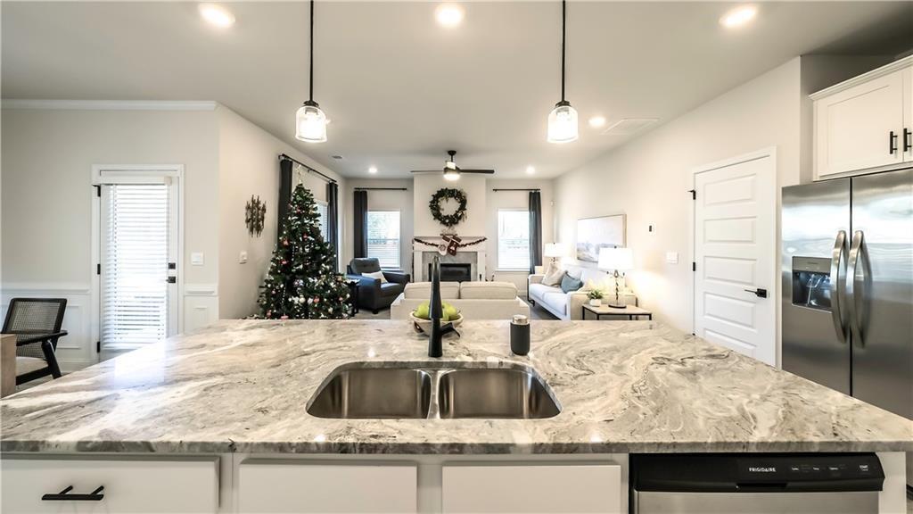 213 Laney Drive Carrollton, GA 30117 - Photo 3 of 36 a kitchen with kitchen island granite countertop a sink and refrigerator
