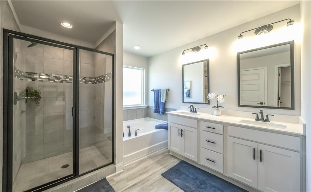 213 Laney Drive Carrollton, GA 30117 - Photo 31 of 36 a bathroom with a double vanity sink mirror and shower