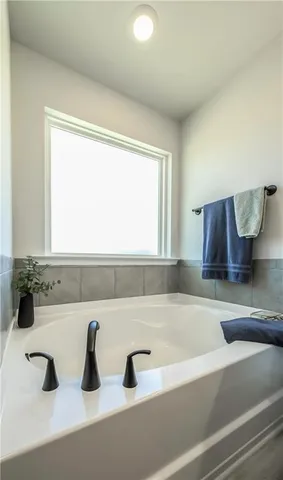 a bathroom with a bathtub and a sink