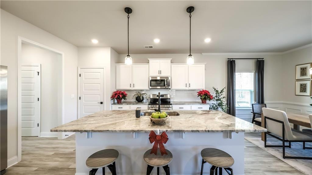 213 Laney Drive Carrollton, GA 30117 - Photo 6 of 36 a kitchen with a dining table chairs and cabinets