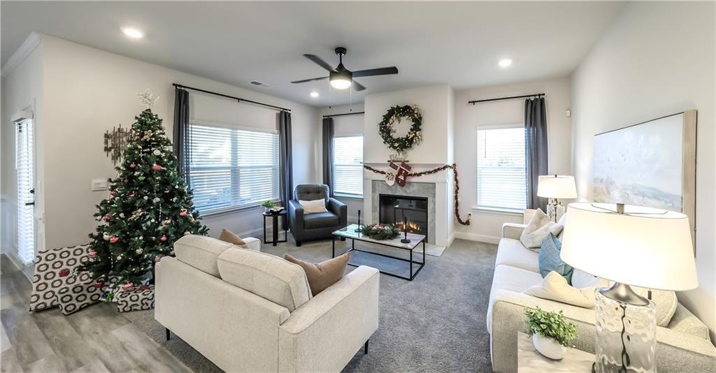 213 Laney Drive Carrollton, GA 30117 - Photo 7 of 36 a living room with furniture a large window and a fireplace