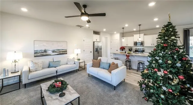 a living room with furniture and a christmas tree