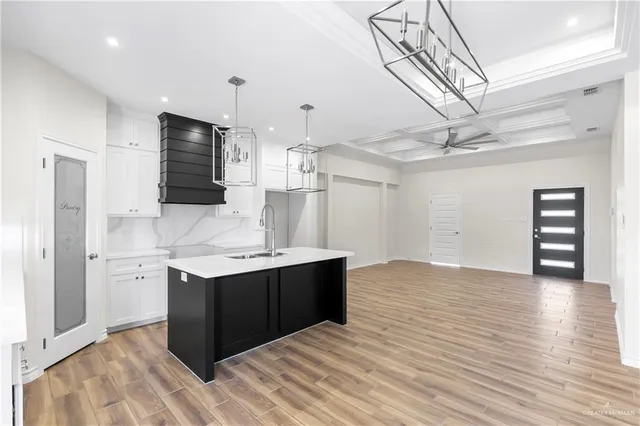 a kitchen with stainless steel appliances a sink and a refrigerator