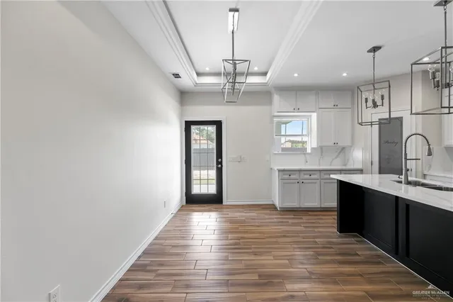 a view of a kitchen with a sink stainless steel appliances and cabinets