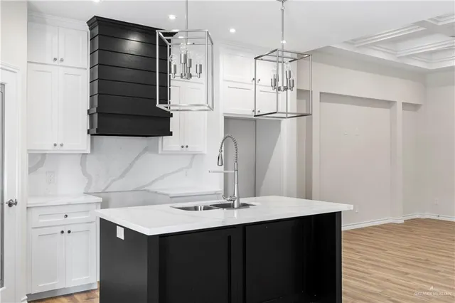 a kitchen with a refrigerator and a sink