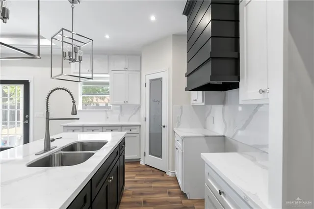 a kitchen with a sink and a refrigerator