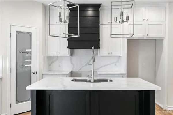a kitchen with a sink and a refrigerator