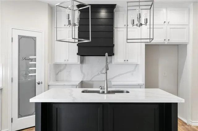 a kitchen with a sink and a refrigerator