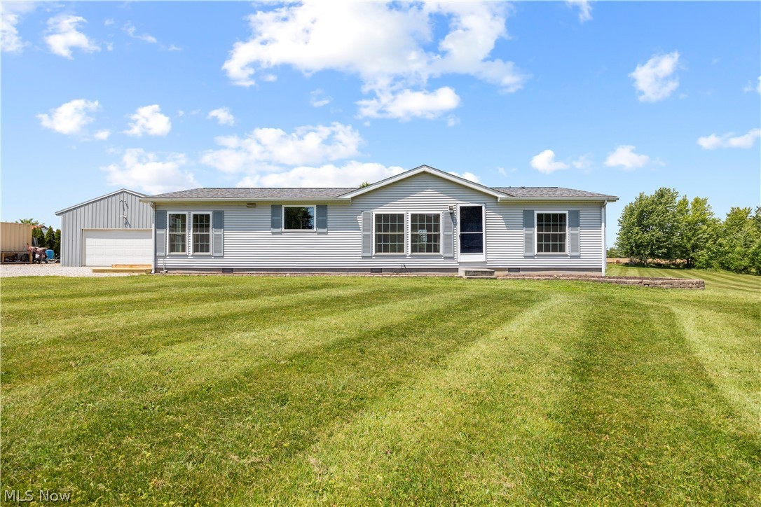 294 Twp 150 Road Sullivan, OH 44880 - Photo 5 of 39 Light gray ranch-style residence featuring a dark gray shingle roof and contrasting blue shutters
