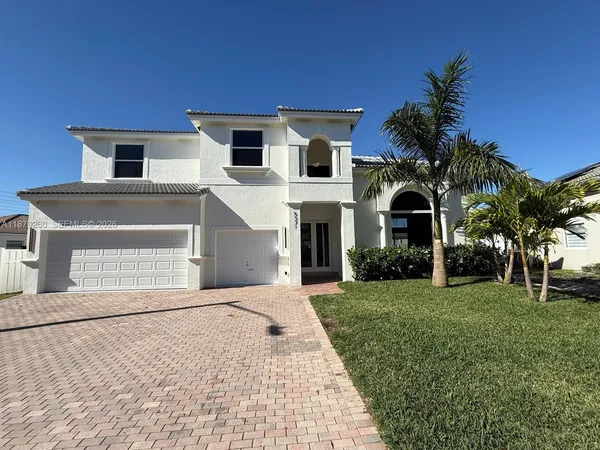 a front view of a house with a yard and garage