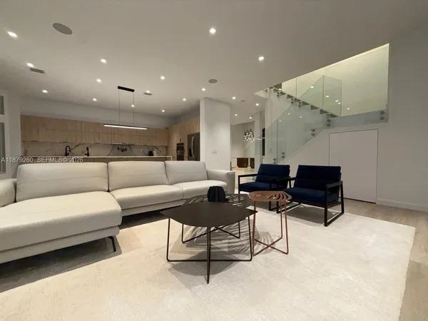 a living room with furniture and a rug