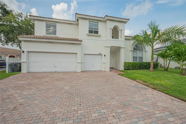 a front view of house with yard and trees