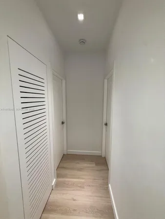 a view of a room with a white door