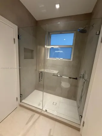 a bathroom with a glass shower door