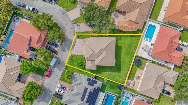 an aerial view of houses with yard