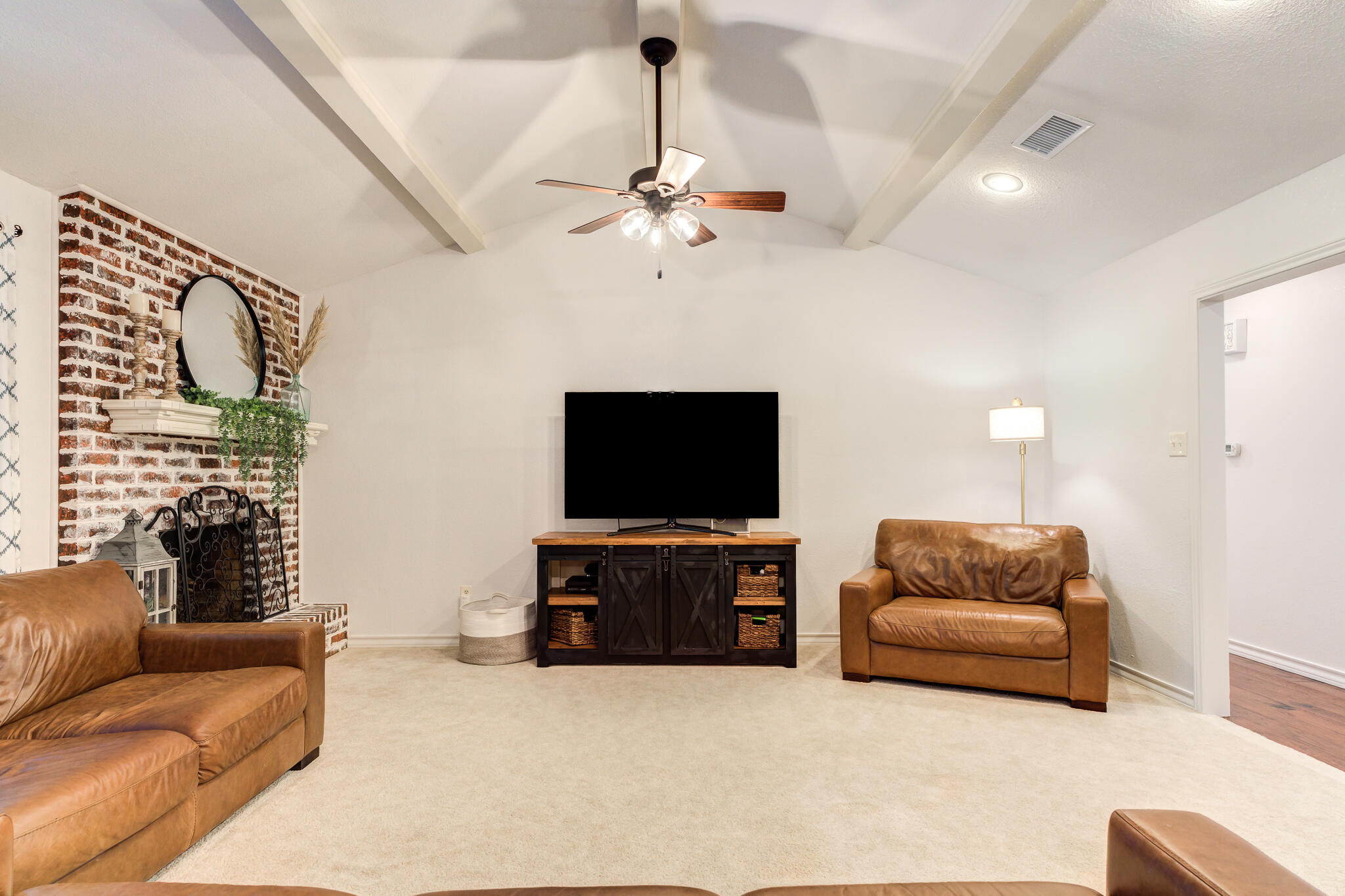 5 West Brookhollow Ransom Canyon, TX 79366 - Photo 14 of 62 a living room with furniture and a flat screen tv
