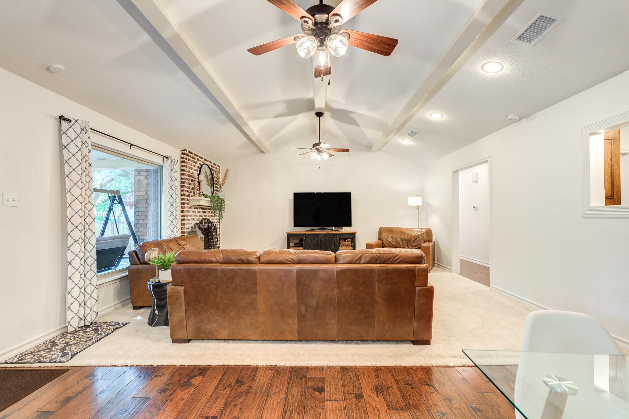 5 West Brookhollow Ransom Canyon, TX 79366 - Photo 16 of 62 a living room with furniture and a flat screen tv
