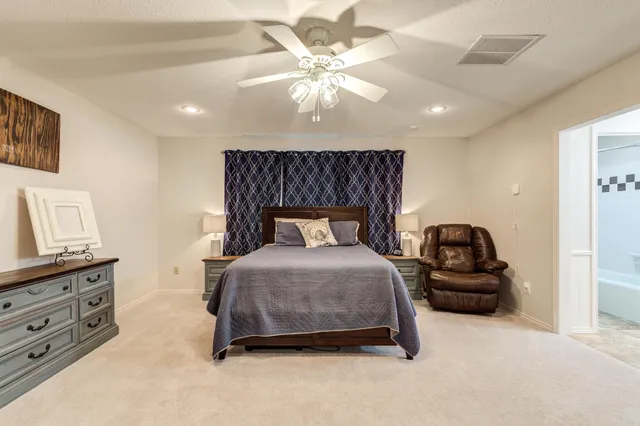a bedroom with furniture and a large window