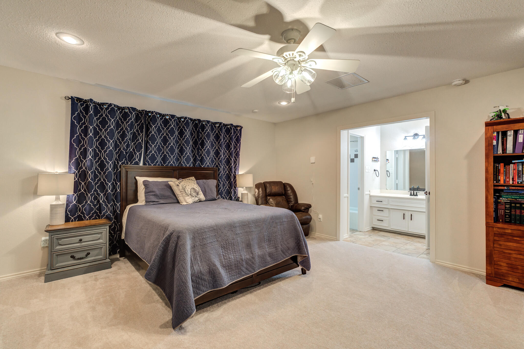 5 West Brookhollow Ransom Canyon, TX 79366 - Photo 40 of 62 a bedroom with a bed and a chandelier