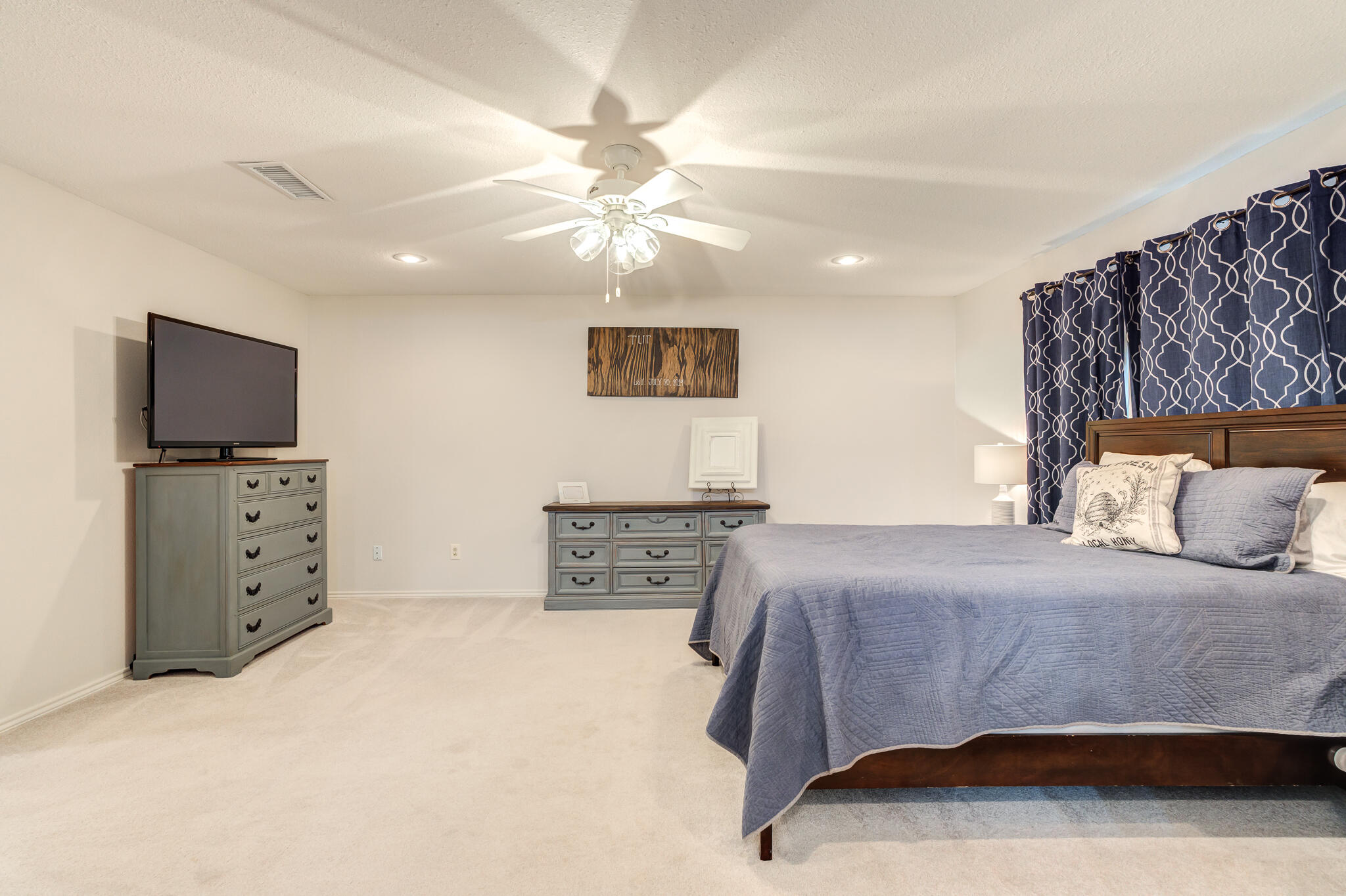 5 West Brookhollow Ransom Canyon, TX 79366 - Photo 42 of 62 a bedroom with a bed and a flat screen tv