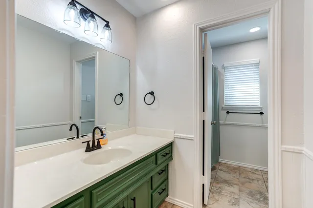 a view of residential houses with outdoor space and trees