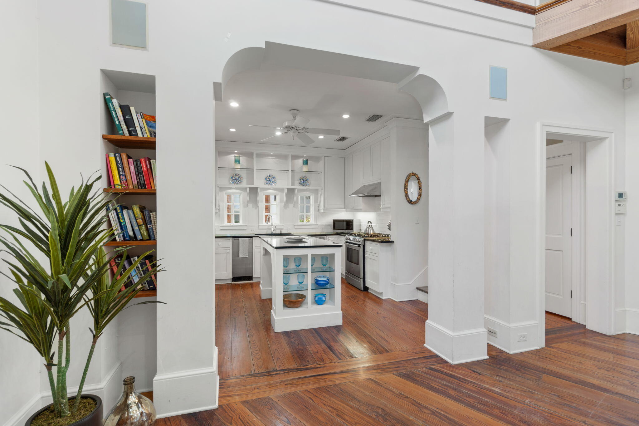 16 South Green Turtle Lane Inlet Beach, FL 32461 - Photo 18 of 59 a kitchen with stainless steel appliances granite countertop a refrigerator a stove a sink and white cabinets with wooden floor