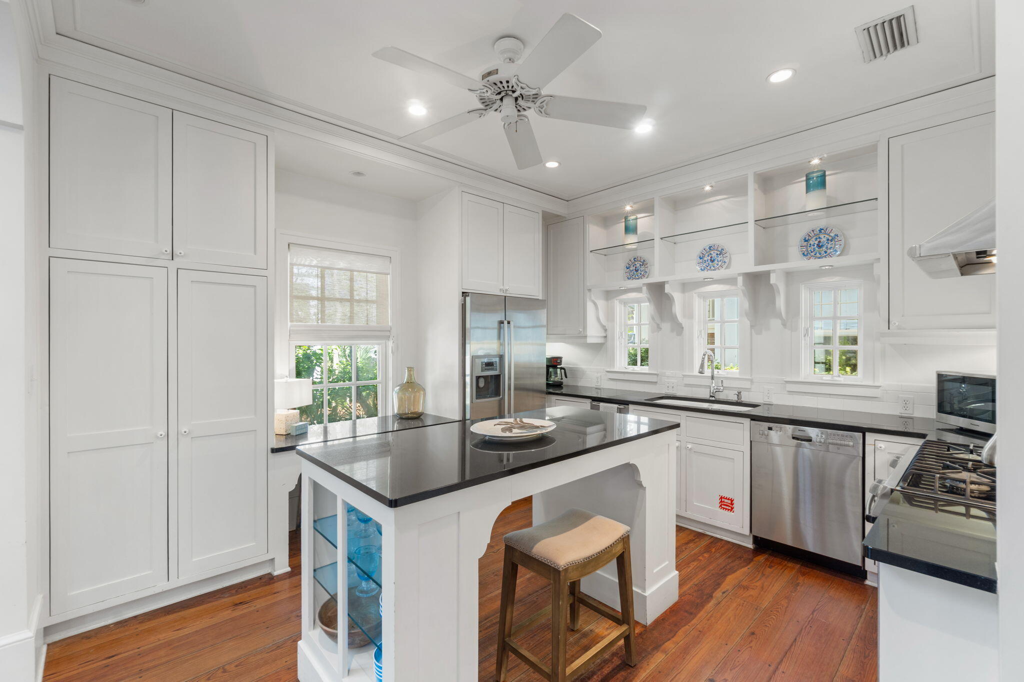 16 South Green Turtle Lane Inlet Beach, FL 32461 - Photo 20 of 59 a kitchen with stainless steel appliances granite countertop a sink and cabinets with wooden floor
