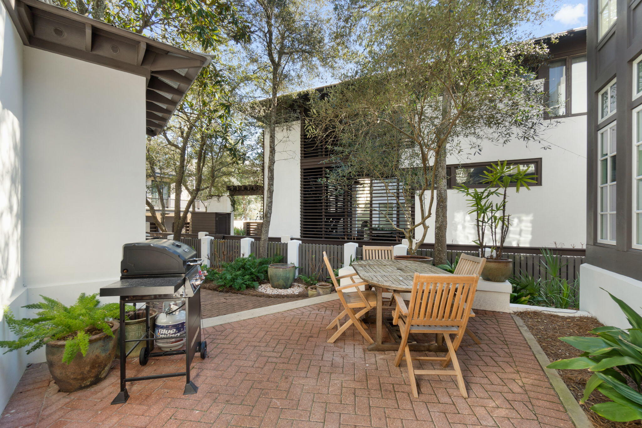 16 South Green Turtle Lane Inlet Beach, FL 32461 - Photo 9 of 59 a view of a patio with table and chairs and potted plants