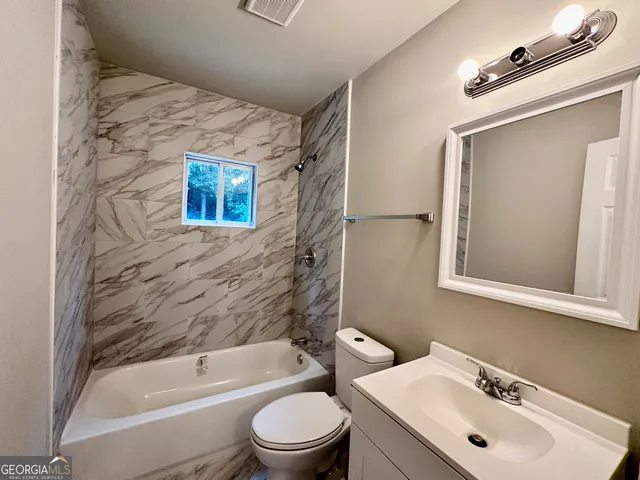 a bathroom with a toilet sink and bathtub