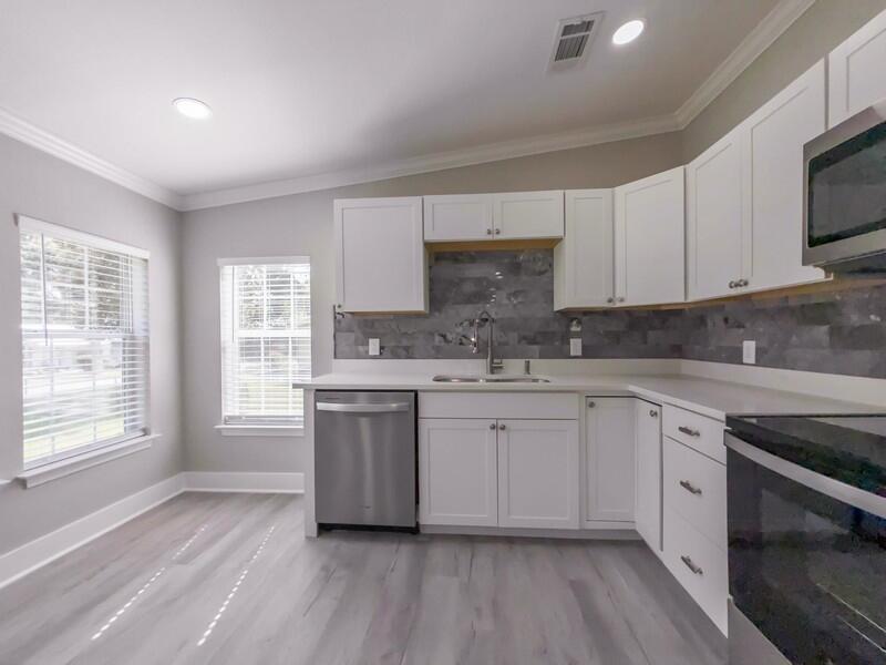 630 West Griffith Avenue Crestview, FL 32536 - Photo 13 of 36 a kitchen with granite countertop white cabinets and white appliances