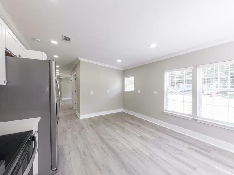 630 West Griffith Avenue Crestview, FL 32536 - Photo 16 of 36 a view of an empty room with wooden floor and a window