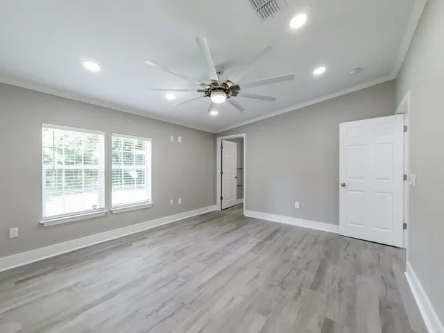 wooden floor in an empty room with a window