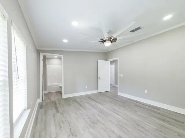 wooden floor in an empty room with a window