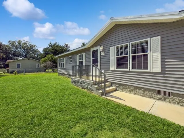 a backyard of a house with lots of green space