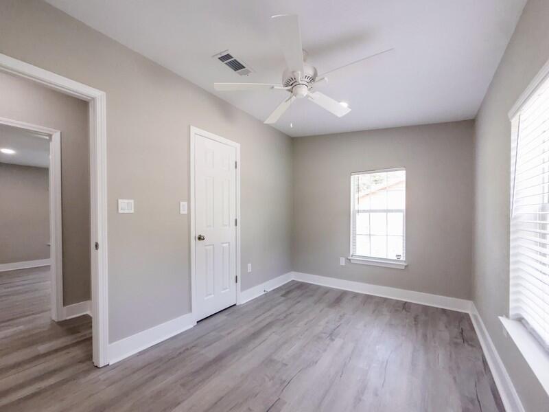 630 West Griffith Avenue Crestview, FL 32536 - Photo 31 of 36 a view of an empty room with wooden floor and a window