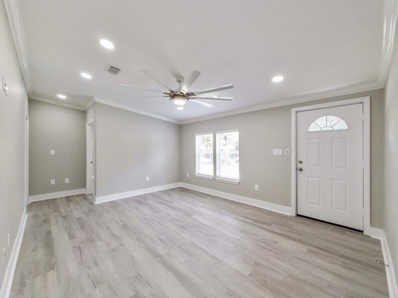 630 West Griffith Avenue Crestview, FL 32536 - Photo 4 of 36 a view of an empty room with wooden floor and a window