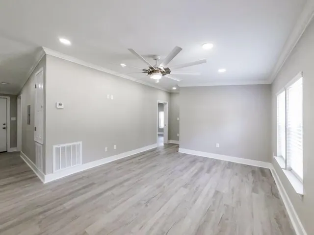 wooden floor in an empty room with a window