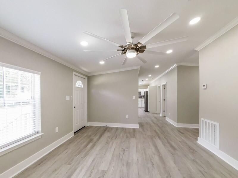 630 West Griffith Avenue Crestview, FL 32536 - Photo 8 of 36 a view of a big room with wooden floor and windows in a room
