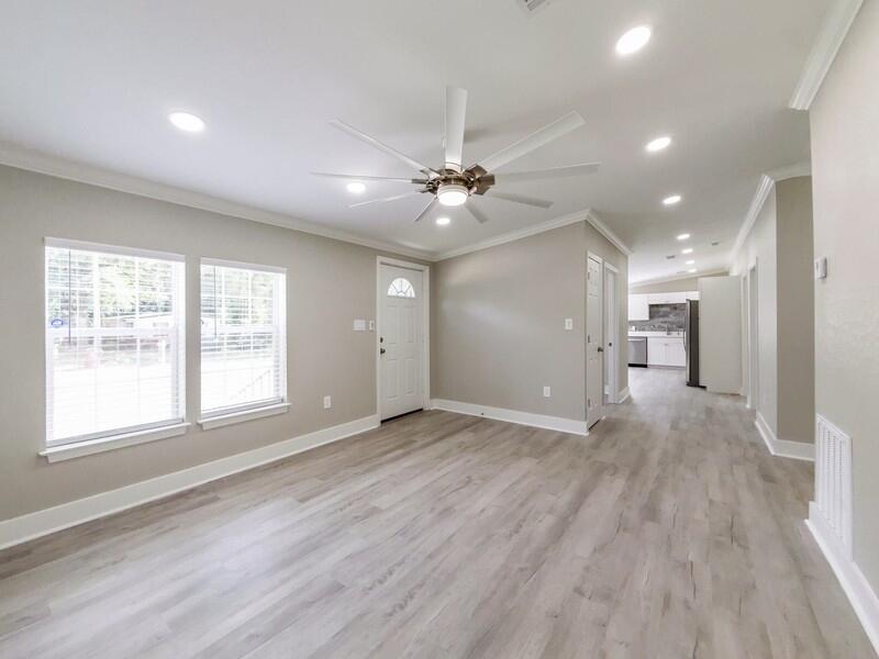 630 West Griffith Avenue Crestview, FL 32536 - Photo 9 of 36 a view of an empty room with a window and a kitchen