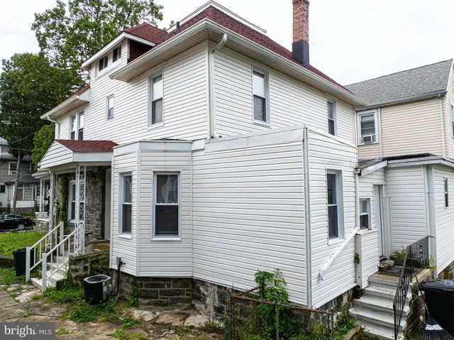 a view of a white house with many windows