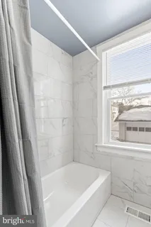 a bath tub sitting next to a window