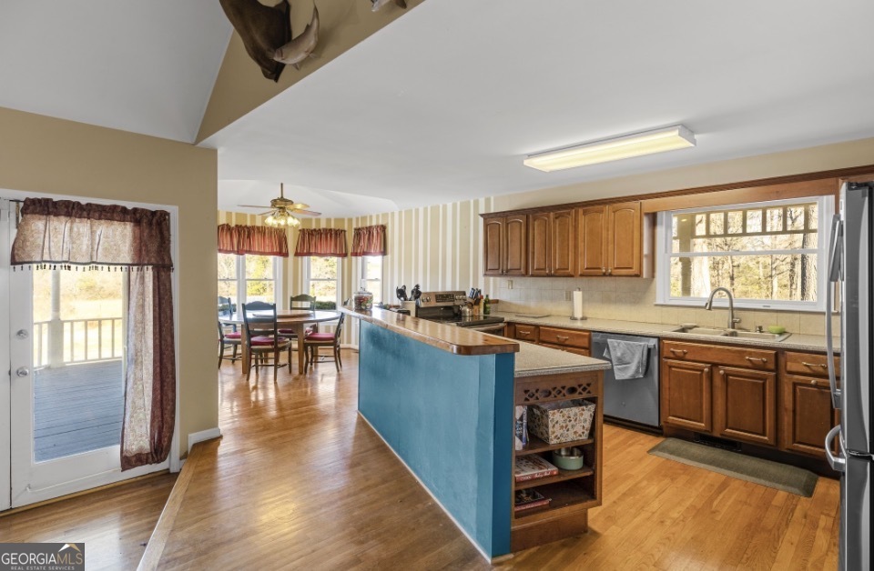 1776 Wax Road Southeast Silver Creek, GA 30173 - Photo 14 of 45 a kitchen with lots of counter top space and dining table